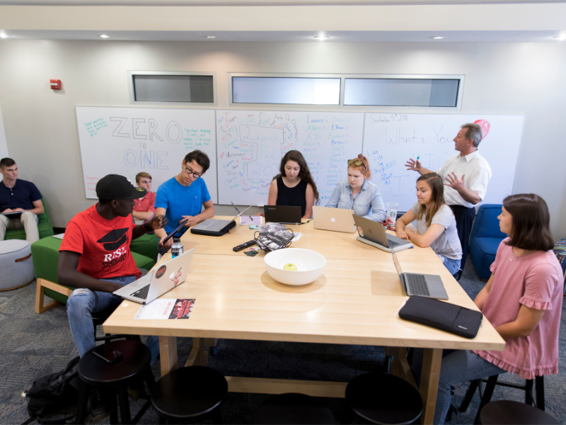 (Back Right) Associate director of Entrepreneurship Program Donald Chambers talking to students during a First-Year Odyssey entrepreneurship class in the Launch Pad in Creswell Residence Hall.